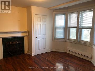Toronto (Moss Park) apartment for rent - A room with a fireplace and a door.