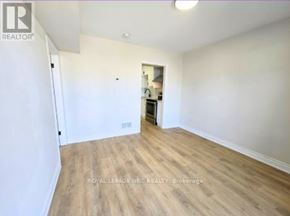 Port Colborne (East Village) fourplex for rent - A room with wooden flooring and white walls, with a doorway leading to another room.