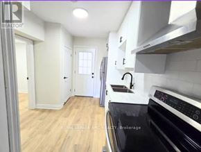 Port Colborne (East Village) fourplex for rent - A kitchen with a black oven and wooden floors.