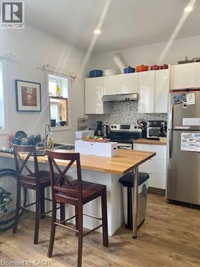 Kitchener apartment for rent - A kitchen with a wooden table and chairs.