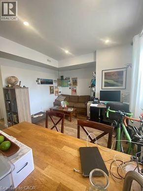 Kitchener apartment for rent - A living room with a couch, a coffee table, and a bicycle.