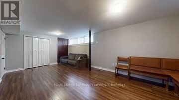 Toronto (West Hill) apartment for rent - A living room with a brown couch and a wooden floor.