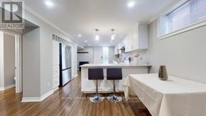 Toronto (West Hill) apartment for rent - A modern kitchen with a bar stool and a dining table.