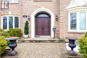 Burlington (Rose) apartment for rent - A red brick house with a brown door and two stone planters.
