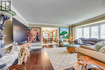 Burlington (Rose) apartment for rent - A living room with a wooden floor and a large painting on the wall.