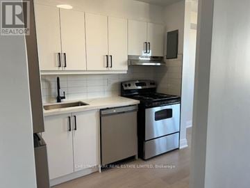 Toronto (Don Valley Village) multi-family for rent - A kitchen with white cabinets and stainless steel appliances.