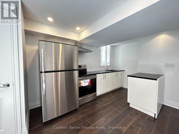 Milton (Cl Clarke) apartment for rent - A kitchen with a stainless steel refrigerator and wooden floors.
