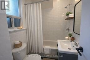 Toronto (South Parkdale) multi-family for rent - A bathroom with a toilet, sink, and shower.