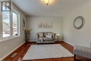 London East (East P) apartment for rent - A living room with a grey couch and a white rug.
