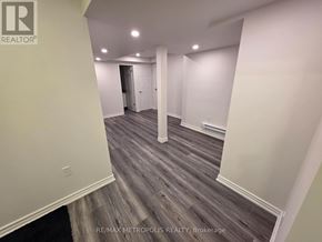 East Gwillimbury (Queensville) apartment for rent - A room with wooden flooring and white walls, with a door at the end of the hallway.