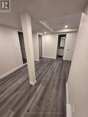 East Gwillimbury (Queensville) apartment for rent - A spacious room with wood flooring and white walls.