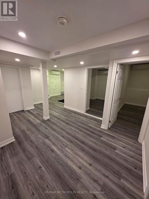 East Gwillimbury (Queensville) apartment for rent - A spacious room with wooden flooring and white walls.