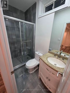 East Gwillimbury (Queensville) apartment for rent - A bathroom with a walk-in shower, toilet, and sink.