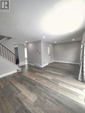 Ottawa apartment for rent - A room with wooden flooring and a staircase.