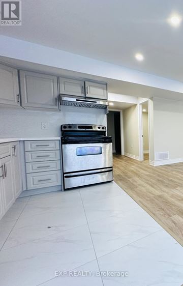 Kitchener apartment for rent - A modern kitchen with a stainless steel oven and wooden flooring.