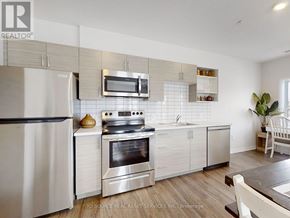 Kawartha Lakes (Lindsay) multi-family for rent - A modern kitchen with a stainless steel oven and microwave above the stove.