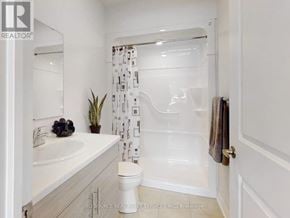 Kawartha Lakes (Lindsay) multi-family for rent - A white bathroom with a toilet, sink, and shower.