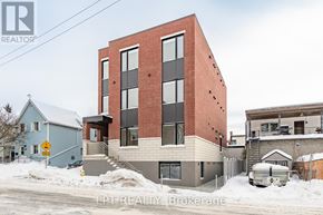 Ottawa multi-family for rent - A red brick building with a white garage door in front.