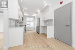 Ottawa multi-family for rent - A modern kitchen with white cabinets and a wooden floor.