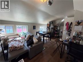 St. Catharines apartment for rent - A living room with a couch, a table, and a chair.