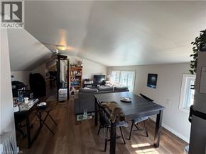St. Catharines apartment for rent - A living room with a dining table and chairs, a couch, and a television.