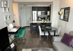 Toronto (Mimico) condo for rent - A modern kitchen with a black table and chairs.