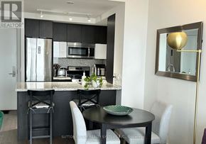 Toronto (Mimico) condo for rent - A modern kitchen with a black and white color scheme.