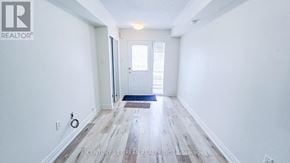 Markham (Greensborough) townhouse for rent - A hallway with a door and a rug on the floor.