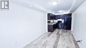 Markham (Greensborough) townhouse for rent - A spacious kitchen area with wooden flooring and white walls.