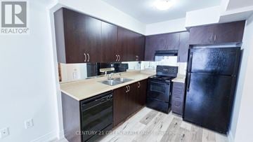 Markham (Greensborough) townhouse for rent - A kitchen with dark brown cabinets and black appliances.