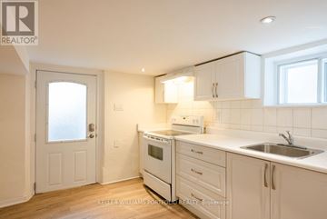 Toronto (Dovercourt-Wallace Emerson-Junction) apartment for rent - A kitchen with white cabinets and a white oven.