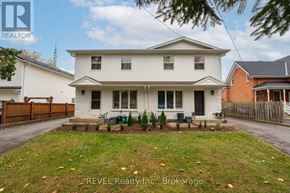 Pelham (Fonthill) fourplex for rent - A white house with a brown fence in front of it.