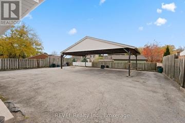 Pelham (Fonthill) fourplex for rent - A large, open, fenced area with a building in the background.