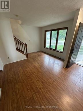 Pelham (Fonthill) fourplex for rent - A room with wooden flooring and a staircase.