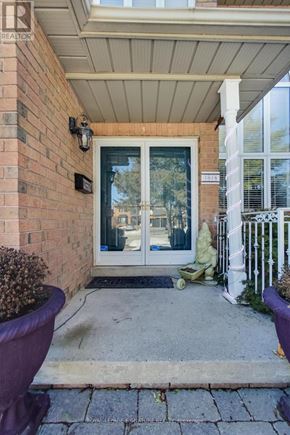 Pickering (Amberlea) apartment for rent - A house entrance with a glass door and a white fence.