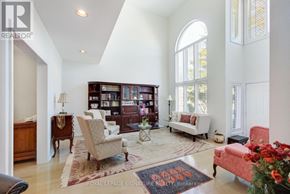 Pickering (Amberlea) apartment for rent - A living room with a large bookshelf and a red rug.