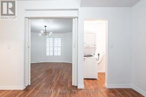 Niagara Falls (Downtown) triplex for rent - A room with a white fridge and a window.