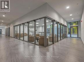 Kingston (Central City East) condo for rent - A spacious office lobby with glass walls and wooden floors.