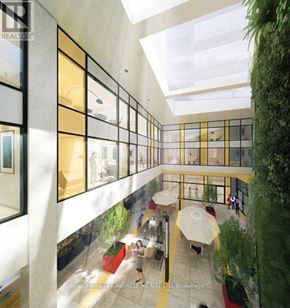 Kingston (Central City East) condo for rent - A modern atrium with a glass ceiling and a green plant on the right side.