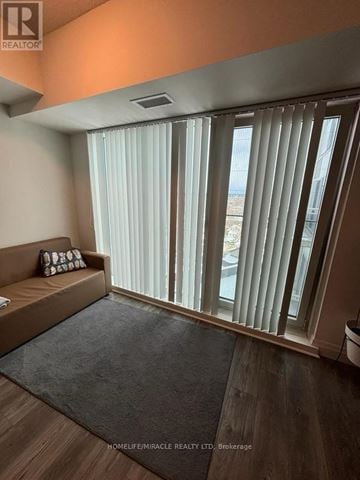 Kingston (Central City East) condo for rent - A living room with a couch and a window with blinds.