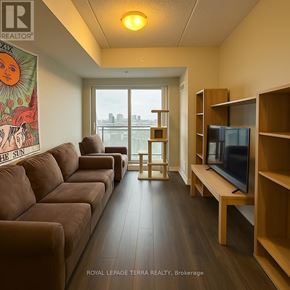 Waterloo condo for rent - A living room with a brown couch and a television.
