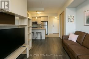 Waterloo condo for rent - A living room with a brown couch and a television.