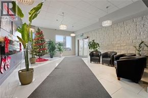 Hamilton apartment for rent - A long hallway with a Christmas tree and a REALTOR sign on the wall.