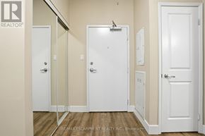 Hamilton (Durand) multi-family for rent - A white door with a glass panel is in the middle of a hallway.