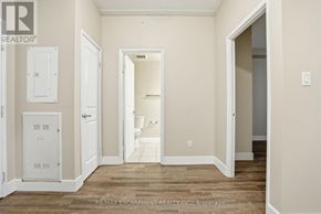 Hamilton (Durand) multi-family for rent - A room with a door, a window, and a wall socket.