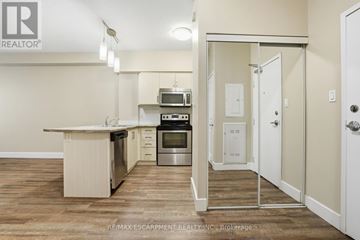 Hamilton (Durand) multi-family for rent - A kitchen with a white counter top and a stainless steel oven.