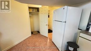 Richmond Hill (Doncrest) apartment for rent - A white refrigerator in a kitchen with a white door and a white wall.
