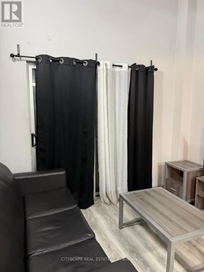 Waterloo condo for rent - A black shower curtain is hanging in a bathroom.