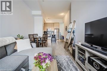 Kitchener condo for rent - A living room with a grey couch and a wooden coffee table.
