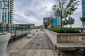 Kitchener condo for rent - A sign on a bench instructs to keep off the garden.